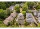 Aerial view highlighting a well-maintained yard with mature trees in a community with sidewalks and manicured landscaping at 8308 Society Pl, Raleigh, NC 27615