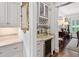 A stylish bar area featuring granite countertops, glass-front cabinets, and a built-in wine cooler at 8308 Society Pl, Raleigh, NC 27615