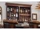 Well-stocked bar area with custom shelving, premium liquors, and stylish seating for entertaining guests at 8308 Society Pl, Raleigh, NC 27615