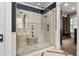 Luxurious walk-in shower featuring dual shower heads and a built-in seat at 8308 Society Pl, Raleigh, NC 27615