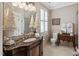 Well-lit bathroom featuring a marble vanity, decorative accents, and tiled flooring at 8308 Society Pl, Raleigh, NC 27615
