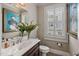 Charming bathroom featuring custom vanity, decorative mirror, unique artwork, and natural light from the window at 8308 Society Pl, Raleigh, NC 27615