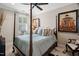 Comfortable bedroom featuring canopy bed, neutral tones, stylish decor and a ceiling fan at 8308 Society Pl, Raleigh, NC 27615