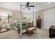 Comfortable bedroom with tropical bedding, furniture and natural light and a ceiling fan at 8308 Society Pl, Raleigh, NC 27615