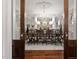 Elegant dining room with hardwood floors, ornate chandelier and a large table surrounded by carved wood chairs at 8308 Society Pl, Raleigh, NC 27615