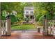 Beautiful home with manicured lawn, mature trees, and a charming water fountain feature at 8308 Society Pl, Raleigh, NC 27615