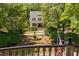 Beautiful home with manicured lawn, mature trees, and a charming water fountain feature at 8308 Society Pl, Raleigh, NC 27615