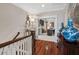 Inviting foyer features hardwood floors, elegant staircase, and detailed trim work leading to the rest of the home at 8308 Society Pl, Raleigh, NC 27615