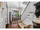 Elegant foyer with hardwood floors, chandelier, ornate trim, staircase, and antique furniture at 8308 Society Pl, Raleigh, NC 27615