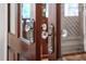 Close up of gorgeous glass door knobs and ornate hardware on front door at 8308 Society Pl, Raleigh, NC 27615