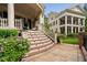 Spacious front porch with ornate staircase and columns, leading to an elegant home at 8308 Society Pl, Raleigh, NC 27615