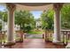 View from the front porch showing manicured garden, fountain, and houses across the street at 8308 Society Pl, Raleigh, NC 27615