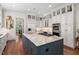 Spacious kitchen with a large granite island and white cabinets at 8308 Society Pl, Raleigh, NC 27615