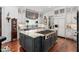 Gourmet kitchen featuring an island with a gas stove and custom cabinetry at 8308 Society Pl, Raleigh, NC 27615