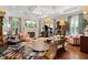 Spacious living room features coffered ceiling, piano, and unique floral rug at 8308 Society Pl, Raleigh, NC 27615