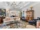 Living room with coffered ceiling, chandelier, decorative rug, and plush seating at 8308 Society Pl, Raleigh, NC 27615
