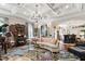 Bright living room with coffered ceiling, piano, and wet bar in background at 8308 Society Pl, Raleigh, NC 27615
