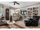 Cozy living room with custom built-in bookshelves, comfortable seating, and a neutral color palette at 8308 Society Pl, Raleigh, NC 27615