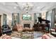 Living room boasts coffered ceiling, piano, fireplace, and floral rug at 8308 Society Pl, Raleigh, NC 27615