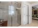 Elegant bathroom showcasing a glass-enclosed shower, tiled walls, and access to the main bedroom at 8308 Society Pl, Raleigh, NC 27615
