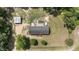 Aerial view of home on a large lot, featuring a detached garage, garden, and mature trees at 921 Sweet Raspberry Lane Ln, Lillington, NC 27546