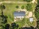 Aerial view of home on a large lot, featuring a detached garage, garden, and mature trees at 921 Sweet Raspberry Lane Ln, Lillington, NC 27546