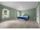 Spacious bedroom with ample natural light, complemented by wood-look flooring and neutral paint at 921 Sweet Raspberry Lane Ln, Lillington, NC 27546