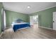 Large bedroom with wood-look flooring leading to a bathroom at 921 Sweet Raspberry Lane Ln, Lillington, NC 27546