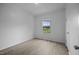White bedroom featuring light wood-look floors and a window at 921 Sweet Raspberry Lane Ln, Lillington, NC 27546