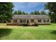 Charming single-story home featuring a wheelchair ramp and landscaped front yard with mature trees at 921 Sweet Raspberry Lane Ln, Lillington, NC 27546