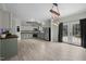 Modern kitchen features sleek appliances, white and green cabinetry, a rustic lighting fixture, and convenient outdoor access at 921 Sweet Raspberry Lane Ln, Lillington, NC 27546