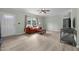 Bright living area features a comfy red couch, large windows, updated flooring, and a welcoming ambiance at 921 Sweet Raspberry Lane Ln, Lillington, NC 27546