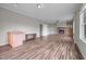 Open living room featuring wood-look floors, wet bar, fireplace, and white trim at 921 Sweet Raspberry Lane Ln, Lillington, NC 27546