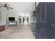 Light-filled living room with sleek laminate floors, neutral paint, and a view into an open kitchen at 921 Sweet Raspberry Lane Ln, Lillington, NC 27546