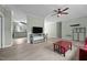 Spacious open-concept featuring views to the kitchen, laminate floors, a ceiling fan and warm neutral paint at 921 Sweet Raspberry Lane Ln, Lillington, NC 27546