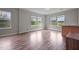 Open living room featuring wood-look floors, white trim and multiple windows at 921 Sweet Raspberry Lane Ln, Lillington, NC 27546