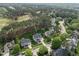 Gorgeous aerial view of a home nestled in a golf course community with lush trees at 925 Hidden Jewel Ln, Wake Forest, NC 27587