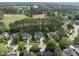 Aerial view of a home nestled in a golf course community with mature trees at 925 Hidden Jewel Ln, Wake Forest, NC 27587