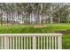 Picturesque backyard with lush lawn, mature trees, and a view from the deck at 925 Hidden Jewel Ln, Wake Forest, NC 27587
