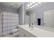 Bright bathroom featuring a white vanity, and blue striped shower curtain at 925 Hidden Jewel Ln, Wake Forest, NC 27587