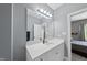 Well-lit bathroom with white vanity, a large mirror and neutral paint at 925 Hidden Jewel Ln, Wake Forest, NC 27587