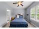 Well-lit bedroom featuring a queen-size bed, neutral walls, and a bright window at 925 Hidden Jewel Ln, Wake Forest, NC 27587
