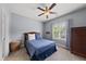 Cozy bedroom with a queen-size bed, wood furniture, and a bright window for natural light at 925 Hidden Jewel Ln, Wake Forest, NC 27587