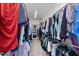 Walk-in closet with hanging clothes and storage, well-organized at 925 Hidden Jewel Ln, Wake Forest, NC 27587