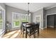 Bright dining room with large windows and a stylish light fixture at 925 Hidden Jewel Ln, Wake Forest, NC 27587