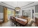 Dining room is adorned with coffered ceiling and a modern light fixture, blending style and comfort at 925 Hidden Jewel Ln, Wake Forest, NC 27587