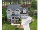 Inviting two-story home with a manicured lawn and a spacious driveway leading to a two-car garage at 925 Hidden Jewel Ln, Wake Forest, NC 27587