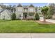 Charming two-story home with lush green lawn and a welcoming covered front porch at 925 Hidden Jewel Ln, Wake Forest, NC 27587