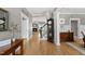 Inviting foyer featuring wood floors, black grandfather clock, and views of living and dining areas at 925 Hidden Jewel Ln, Wake Forest, NC 27587