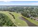 Beautiful aerial view of a golf course with a pond, sand traps and manicured fairways at 925 Hidden Jewel Ln, Wake Forest, NC 27587